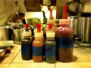TinyBottlesH2OKitchen Bottles of beet juice, kimchi-Tabasco gel, kimchi mayo, miso-mustard, mushroom-truffle syrup at Jason's Hook's H2O Kitchen
